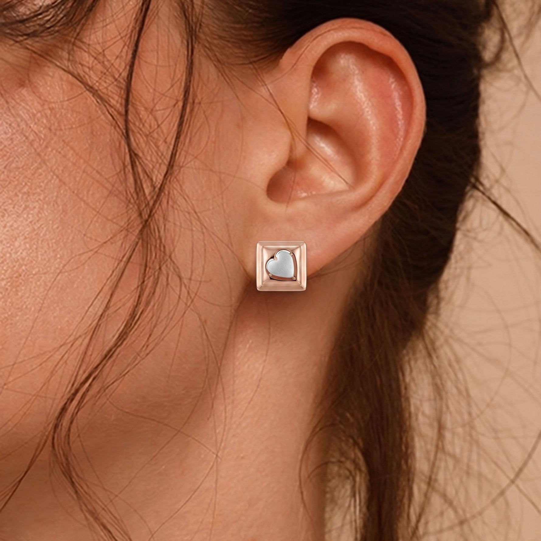 Close-up of an ear wearing a rose gold earring